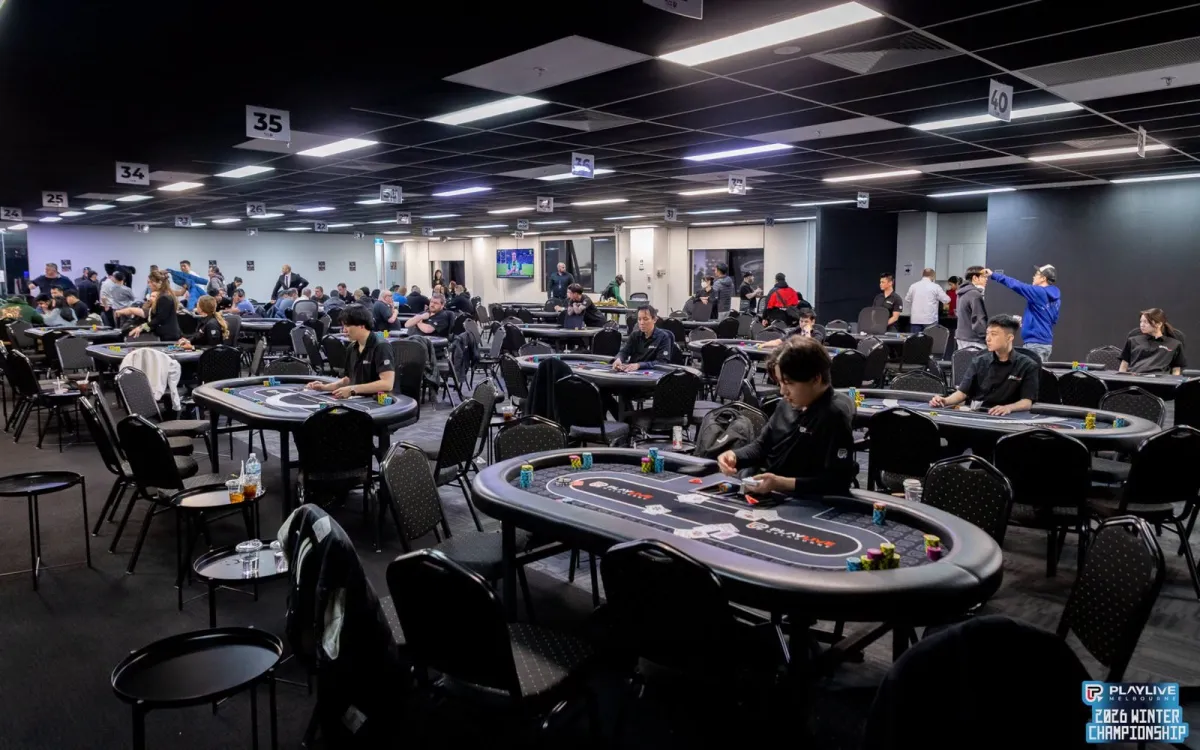 The championship room with dealers seated at chip-stacked tables, waiting for players ahead of a Winter Championship flight.